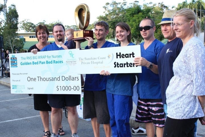 Nurses with the prize cheque at one of our Golden Bed Pan bed race events